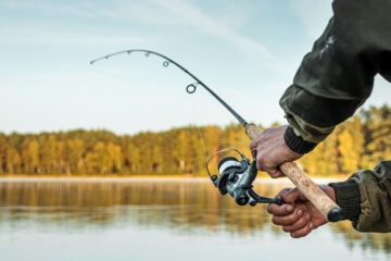 Hands of a fisherman using a rod and reel bait fishing